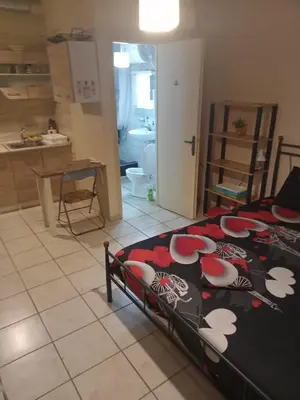 a bedroom with a bed with flowers on it at Athens Koukaki - Closer Metro station Sygrou-Fix in Athens