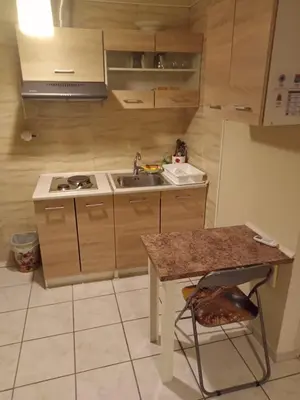 a kitchen with a sink and a stove and a table at Athens Koukaki - Closer Metro station Sygrou-Fix in Athens