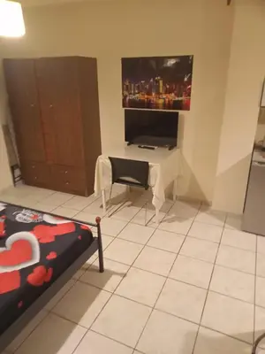 a living room with a table and a tv at Athens Koukaki - Closer Metro station Sygrou-Fix in Athens