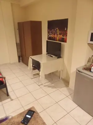 a kitchen with a table with a computer on it at Athens Koukaki - Closer Metro station Sygrou-Fix in Athens