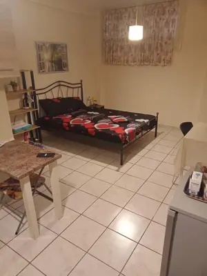 a bedroom with a bed and a table in it at Athens Koukaki - Closer Metro station Sygrou-Fix in Athens