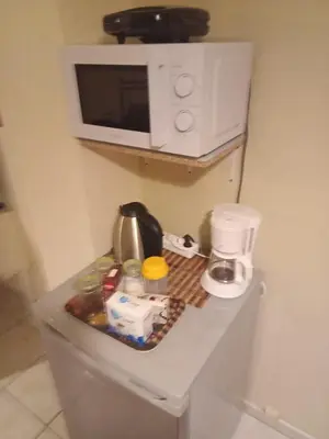 a microwave sitting on top of a counter in a kitchen at Athens Koukaki - Closer Metro station Sygrou-Fix in Athens