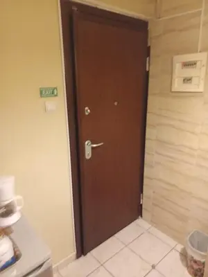 a brown door in a kitchen with a tile floor at Athens Koukaki - Closer Metro station Sygrou-Fix in Athens