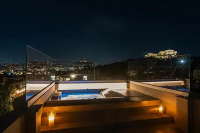 a hot tub on top of a building at night at Historic Villa with Hot Tub Beneath the Acropolis in Athens