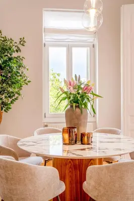 a dining room with a table and chairs and a window at Historic Villa with Hot Tub Beneath the Acropolis in Athens