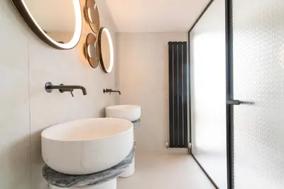 a bathroom with a large white sink and mirrors at Historic Villa with Hot Tub Beneath the Acropolis in Athens