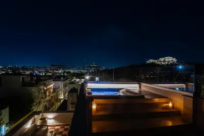 a hot tub on the roof of a building at night at Historic Villa with Hot Tub Beneath the Acropolis in Athens