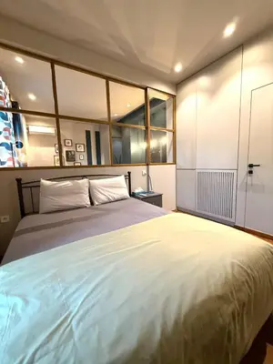 a bedroom with a large bed and some windows at Cosy, Athens core fully renovated apartment in Athens