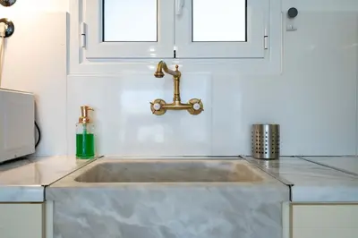a kitchen sink with a faucet on top of it at City Panorama Studio by ΜΡS in Athens
