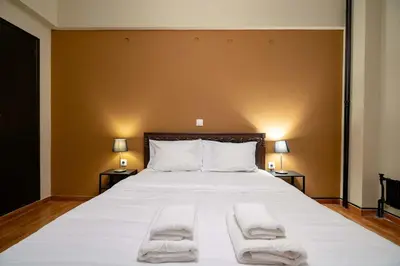 a bedroom with a large bed with two towels on it at Warm 2BR Apt - Central Kypseli by ΜΡS in Athens