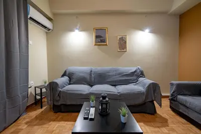a living room with a couch and a table at Warm 2BR Apt - Central Kypseli by ΜΡS in Athens