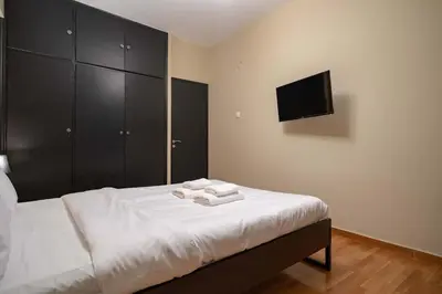 a bedroom with a bed with two towels on it at Warm 2BR Apt - Central Kypseli by ΜΡS in Athens