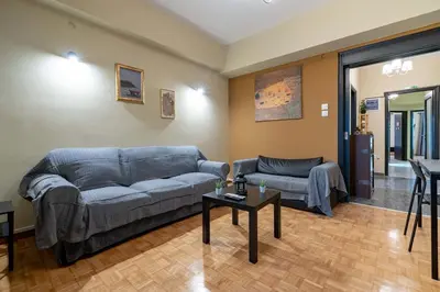 a living room with a couch and a table at Warm 2BR Apt - Central Kypseli by ΜΡS in Athens