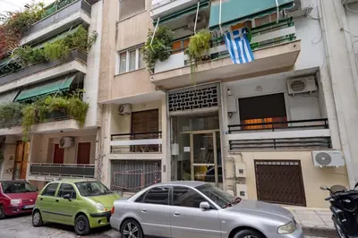 two cars parked in front of a building at Warm 2BR Apt - Central Kypseli by ΜΡS in Athens