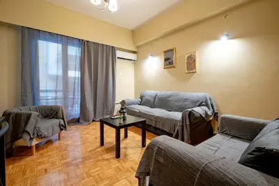 a living room with two couches and a table at Warm 2BR Apt - Central Kypseli by ΜΡS in Athens