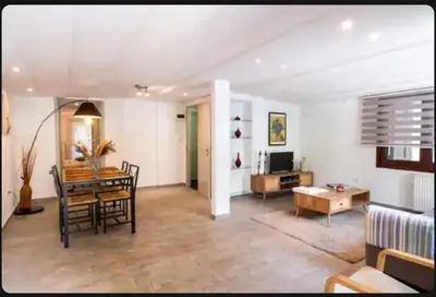 a living room with a table and a dining room at Detached Garden House in Athens