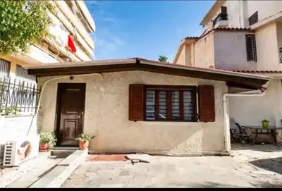 a small house with a window and a patio at Detached Garden House in Athens