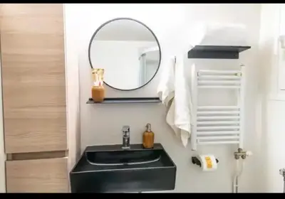 a bathroom with a black sink and a mirror at Detached Garden House in Athens