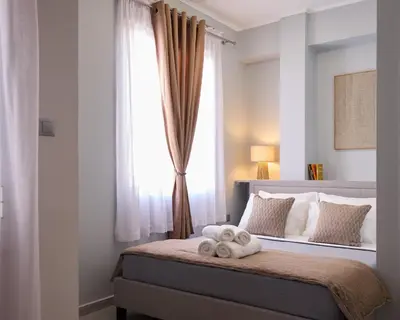 a bedroom with a bed with towels on it at Sofokleous central studio in Athens