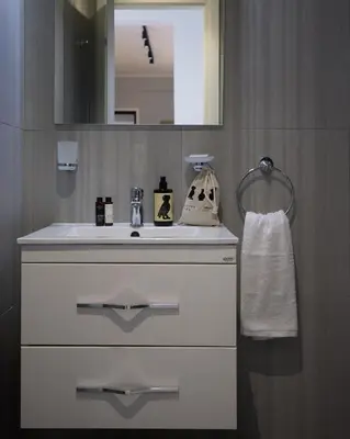 a bathroom with a white sink and a mirror at Sofokleous central studio in Athens