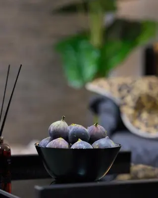a bowl of figs sitting on top of a table at Sofokleous central studio in Athens