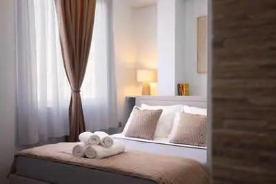 a bedroom with a bed with two towels on it at Sofokleous central studio in Athens