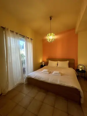 a bedroom with a large bed and a window at City Garden Escape with a View! in Athens