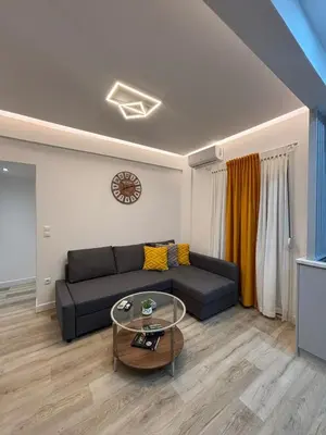 a living room with a couch and a glass table at CasaCentrale in Athens