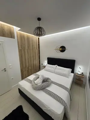 a bedroom with a large white bed with a blanket at CasaCentrale in Athens