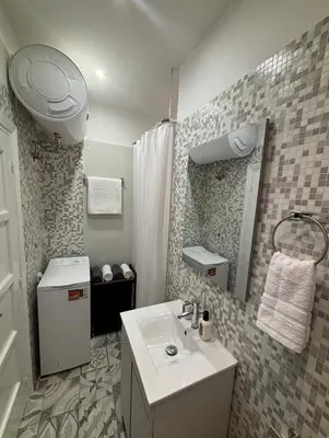 a small bathroom with a sink and a mirror at CasaCentrale in Athens