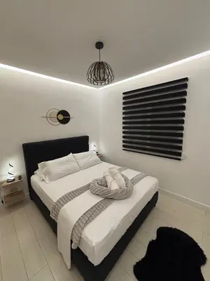 a bedroom with a bed with a towel on it at CasaCentrale in Athens