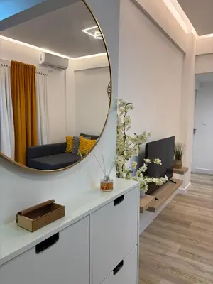 a living room with a mirror and a tv at CasaCentrale in Athens