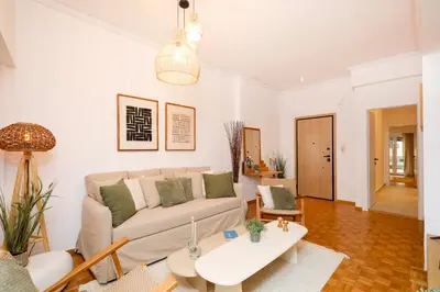 a living room with a couch and a table at Kallimarmaro Gem II in Athens