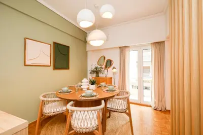 a dining room with a wooden table and chairs at Kallimarmaro Gem II in Athens