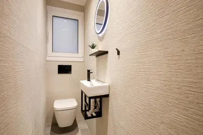 a bathroom with a sink and a toilet and a mirror at Kallimarmaro Gem II in Athens