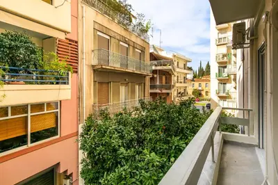 an apartment balcony with plants on the side of a building at Kallimarmaro Gem II in Athens