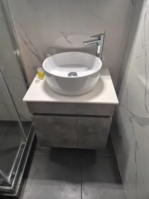a bathroom with a white bowl sink on a counter at City Harmony Flat in Athens