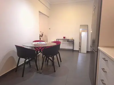 a kitchen and dining room with a table and chairs at City Harmony Flat in Athens