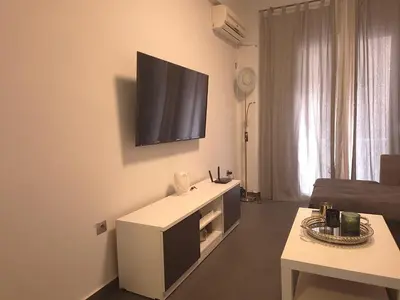 a living room with a flat screen tv on the wall at City Harmony Flat in Athens
