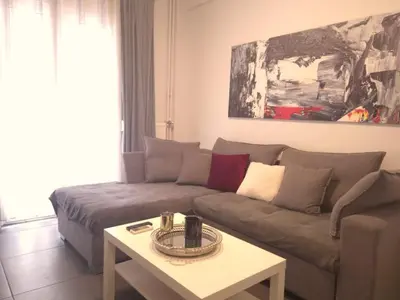a living room with a couch and a table at City Harmony Flat in Athens