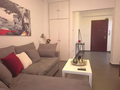 a living room with a couch and a table at City Harmony Flat in Athens