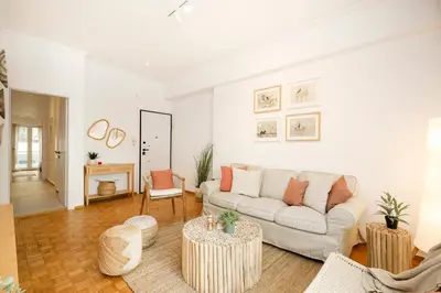 a living room with a couch and two tables at Kallimarmaro Gem III in Athens