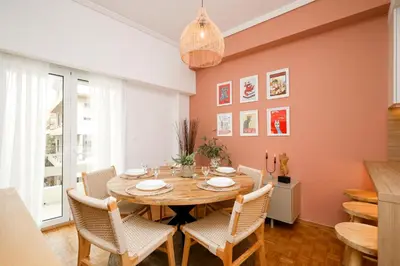 a dining room with a wooden table and chairs at Kallimarmaro Gem III in Athens