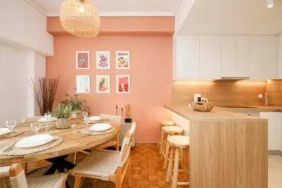 a kitchen and dining room with a wooden table and chairs at Kallimarmaro Gem III in Athens