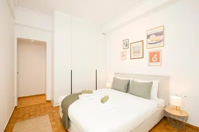 a bedroom with a large white bed in a room at Kallimarmaro Gem I in Athens