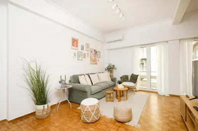 a living room with a couch and a table at Kallimarmaro Gem I in Athens