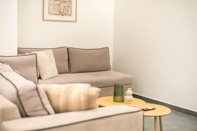 a living room with a couch and a table at Piraeus Apartment in Piraeus