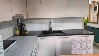 a kitchen with white cabinets and a sink at Long-Stay Family & Work Oasis -20 min to Center & Sea in Piraeus