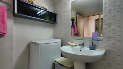 a white bathroom with a sink and a mirror at Long-Stay Family & Work Oasis -20 min to Center & Sea in Piraeus