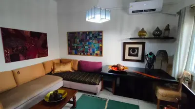 a living room with a couch and a table at Long-Stay Family & Work Oasis -20 min to Center & Sea in Piraeus
